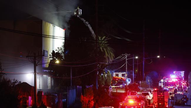 Fire and rescue personnel at the storage facility in Kirawee on Friday. Picture: Jonathan Ng