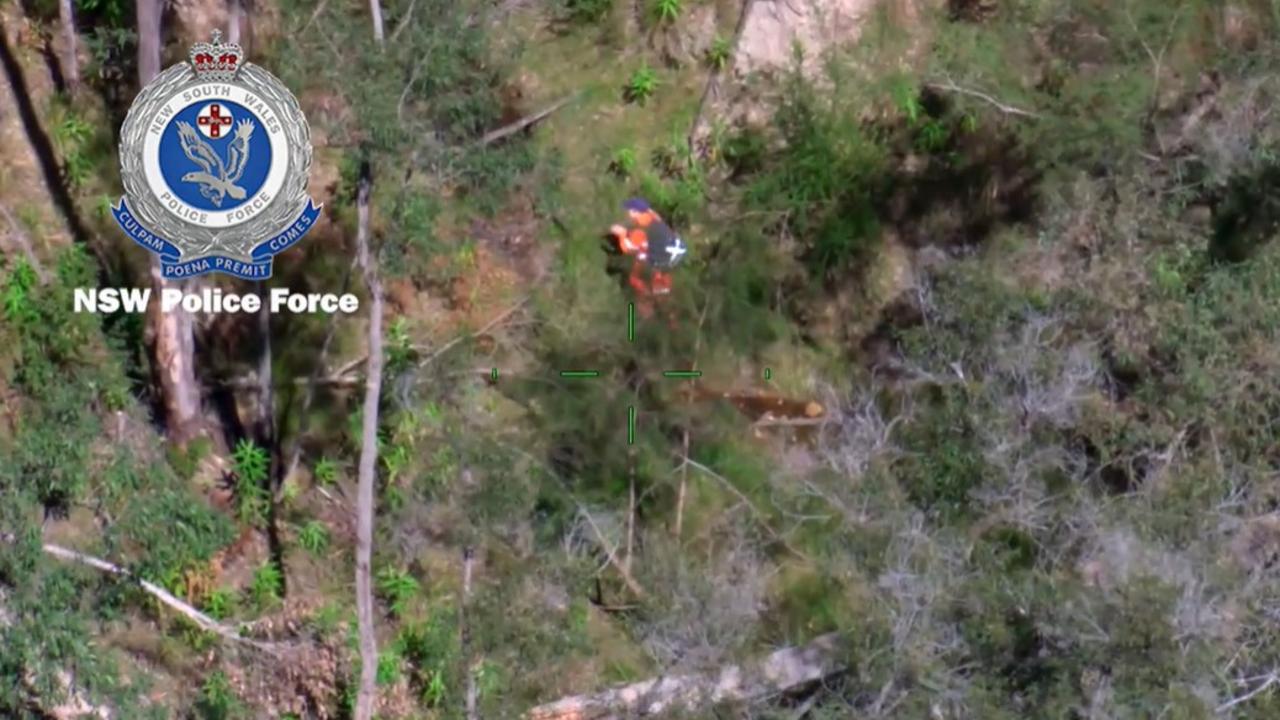 An SES member claps to create noise at the creek site. Picture: NSW Police