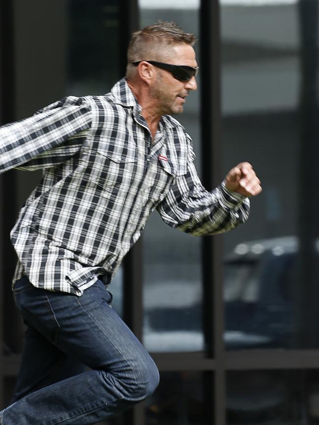 Matthew Page runs from the Cairns Court House.