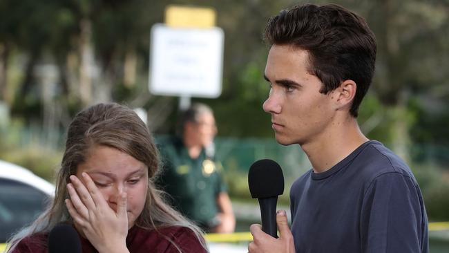 David Hogg interviews fellow shooting massacre survivor Kelsey Friend outside  Marjory Stoneman Douglas High School. Picture: AFP