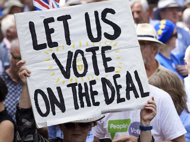 (FILES) In this file photo taken on June 23, 2018, demonstrators carry banners and flags as they participate in the People's March demanding a People's Vote on the final Brexit deal, in central London on the second anniversary of the 2016 referendum. - Hopes for a second referendum on EU membership are rising in Britain amid heightened uncertainty over Brexit, but big hurdles remain -- from the timing to legal complexities on both sides of the Channel. (Photo by Niklas HALLE'N / AFP)