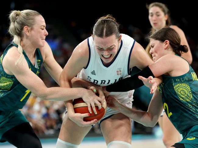 PARIS, FRANCE - AUGUST 07: Angela Dugalic #32 of Team Serbia competes for the ball against Tess Madgen #7 and Jade Melbourne #2 of Team Australia  during the Women's Quarterfinal match between Team Serbia and Team Australia on day twelve of the Olympic Games Paris 2024 at Bercy Arena on August 07, 2024 in Paris, France. (Photo by Gregory Shamus/Getty Images)