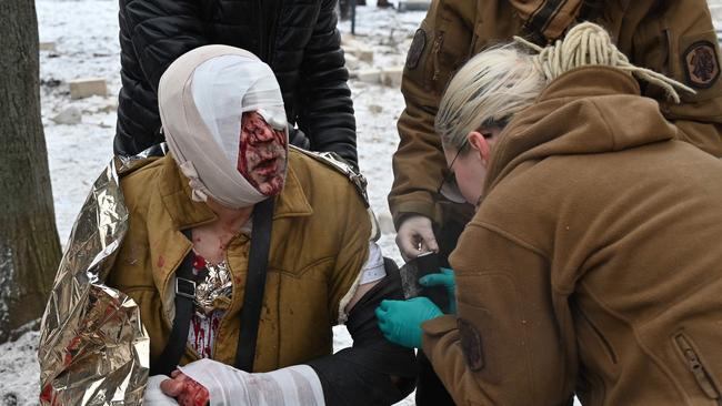 Medical staff provide assistance to a man injured in Kharkiv. Picture: AFP