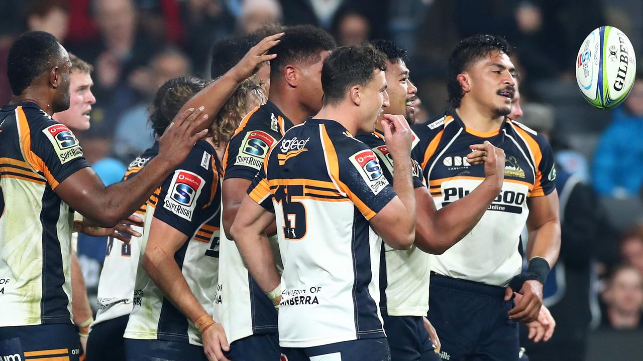 Folau Fainga'a of the Brumbies celebrates scoring a try.