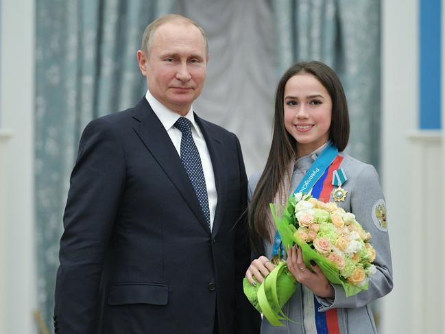 Russian President Vladimir Putin, and Alina Zagitova, gold medalist in the women's figure skating of the 2018 Pyeongchang Winter Olympic Games with the Order of Friendship pose for a photo during an awarding ceremony at the Kremlin in Moscow, Russia, Wednesday, Feb. 28, 2018. (Alexei Druzhinin, Sputnik, Kremlin Pool Photo via AP)