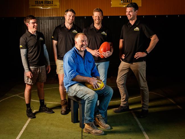 TIGERLAND: Mark Slotegraaf, Tom Cooper, Lee Curnow and Dylan Brodie standing behind Brett Shepherd (stepfather of Lachie Neale) in the change rooms of the Kybybolite Football Club. Picture: Matt Turner