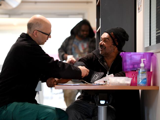 Community Paramedic Phil Forrest gives Jason 'Spoony' Saunders a health check at Stepping Stones Day Centre. Photo: Tricia Watkinson