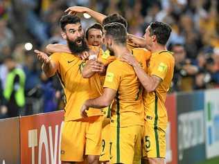 BIG NIGHT: Australia's Mile Jedinak (left), celebrates after scoring against Honduras. Willowburn Football Club will have Australia's match against France live on the big screen tonight. Picture: BRENDAN ESPOSITO