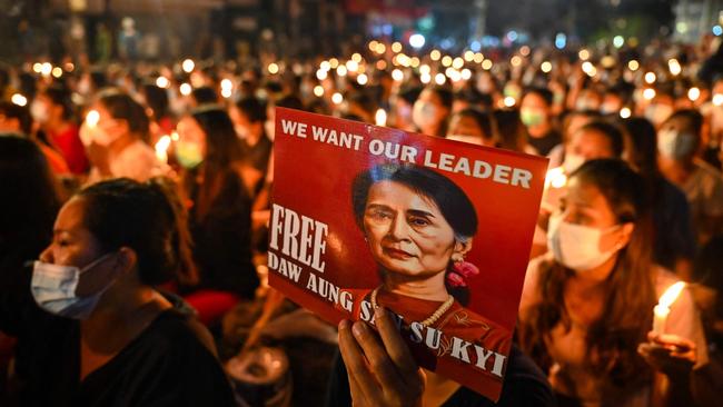 A protester holds a poster with an image of detained civilian leader Aung San Suu Kyi during a candlelight vigil to honour those who have died during demonstrations against the Myanmar military coup. Picture: AFP