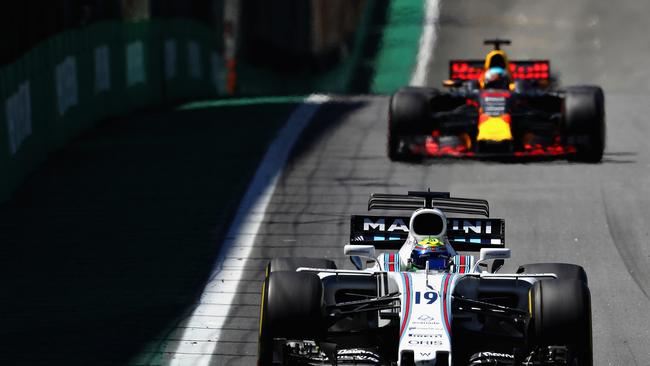 Bulls hit: Felipe Massa of Brazil holds off the Red Bull of Daniel Ricciardo at the Brazil Formula One Grand Prix. Picture: Getty Images