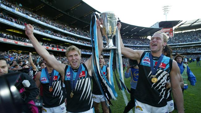 Kane and Chad Cornes, who have both been ranked in the top 30 in The Advertiser’s ranking of Port Adelaide’s top 50 Greatest Players, celebrate the club’s 2004 premiership.