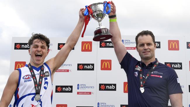 Oakleigh Chargers co-captain Trent Bianco and coach Leigh Clarke lift the NAB League Boys premiership cup. Picture: Andy Brownbill