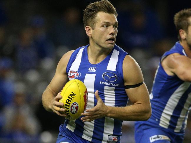 Shaun Higgins of the Kangaroos (left) runs forward with team mate Jamie Macmillan (centre) shepherding Jack Riewoldt of the Tigers during the Round 8 AFL match between the North Melbourne Kangaroos and the Richmond Tigers at Etihad Stadium in Melbourne, Sunday, May 13, 2018. (AAP Image/Hamish Blair) NO ARCHIVING, EDITORIAL USE ONLY