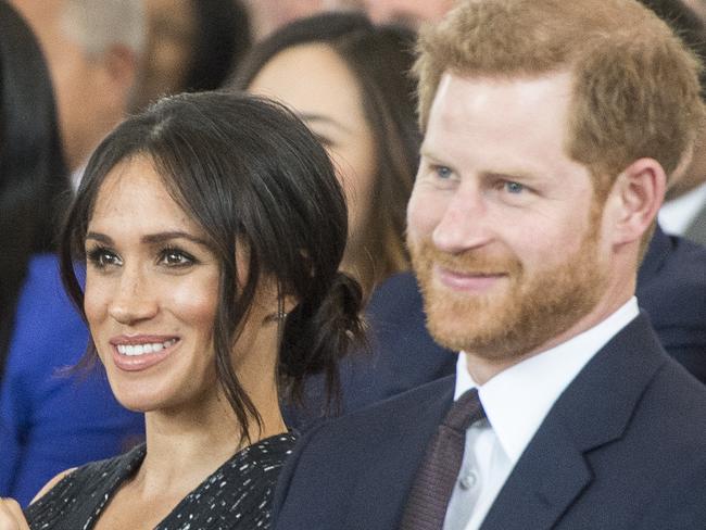 LONDON, ENGLAND - APRIL 23: Prime Minister Theresa May (L), Prince Harry (R) and Meghan Markle (C) attend a memorial service at St Martin-in-the-Fields in Trafalgar Square to commemorate the 25th anniversary of the murder of Stephen Lawrence on April 23, 2018 in London, England.. The 18-year-old murder victim was fatally stabbed by a gang of racists in Eltham, south-east London, on April 22 1993. (Photo by David Parker-WPA Pool/Getty Images)