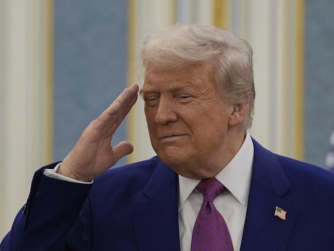 President Donald Trump salutes as he greets with Saudi Crown Prince Mohammed bin Salman delegations at the Royal Palace in Riyadh, Saudi Arabia, Tuesday, May 13, 2025. (AP Photo/Alex Brandon)