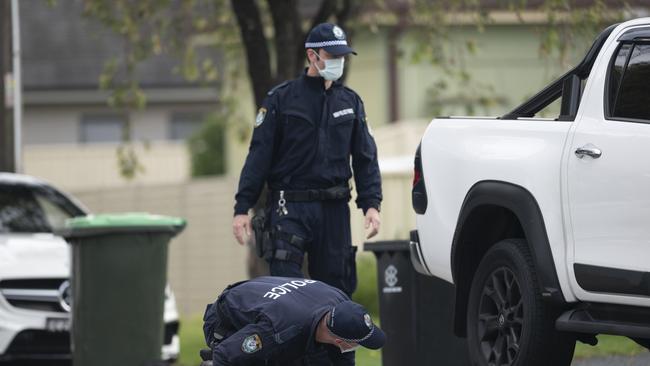 Police look for evidence in surrounding homes and along the streets near Elomar’s home on Third Avenue in Condell Park.