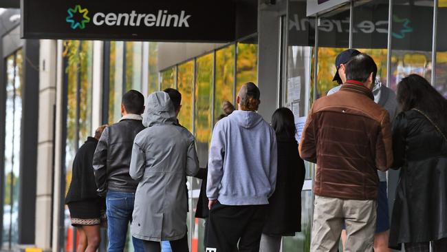 People queue up outside a Melbourne Centrelink office. Picture: AFP