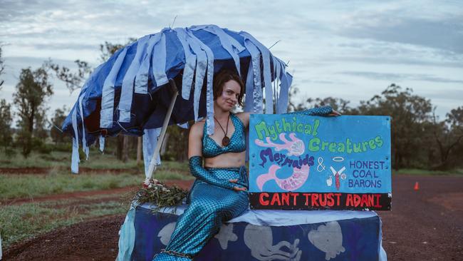 Janie Gibson, dressed in a mermaid outfit, chained to a cattle grid prevents workers from entering the BMD work camp and continuing work on the Adani railway corridor.