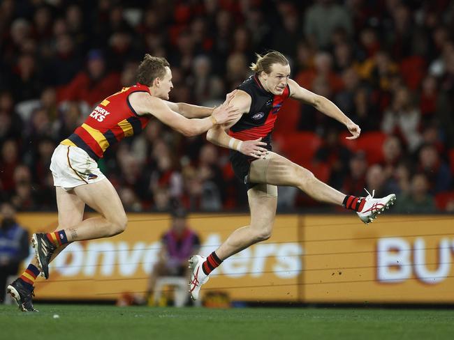 Mason Redman kicks long against the Crows.