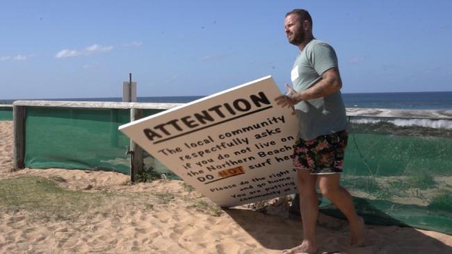 Matt Champion, of Elanora Heights, was so upset at the unauthorised sign calling on people who do not live on the northern beaches to keep away from North Narrabeen Beach that he cut it down. Picture: Supplied