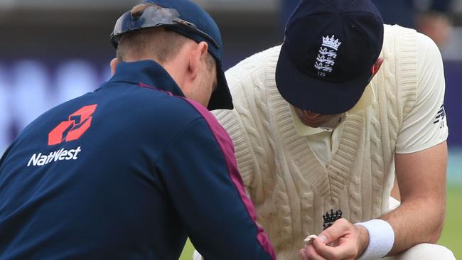 Jimmy Anderson gets some attention on his ailing calf muscle.