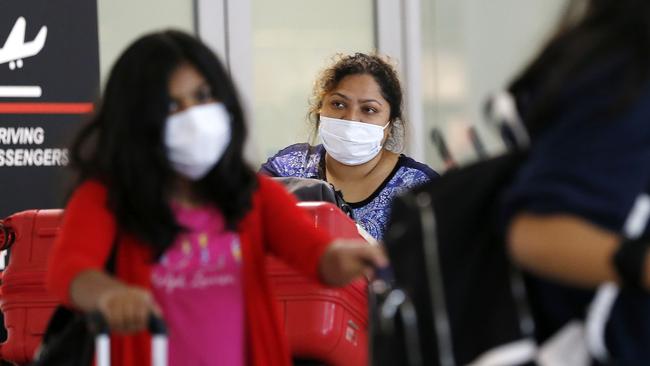 Australians from China have been flying back from China and Hong Kong wearing masks. Picture: Josh Woning.