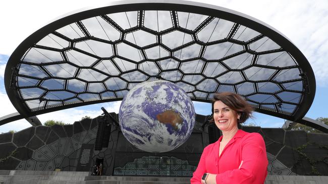 HOTA CEO Criena Gehrke next to a major earth installation, GAIA by Luke Jerram, which was suspended from HOTA's Outdoor Stage. Picture: Glenn Hampson.