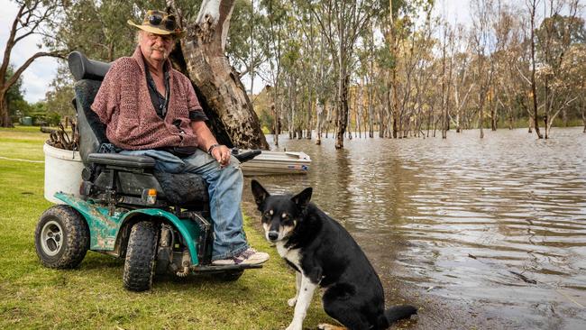 James Watts and his dog Joe next to the rising river near his Marks Landing home. Picture: Tom Huntley