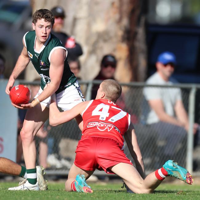 Echuca’s Harry Milburn evades Shepparton Swans’ Harper Simpson. Pictures: Yuri Kouzmin