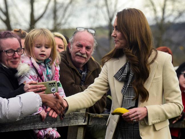 Kate hands Lily-Rose Logan back her toy banana after the little girl dropped it. Picture: AFP