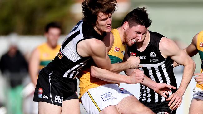 Jared Polec pressures Nick O'Brien as he gets a kick off. Picture: Calum Robertson.