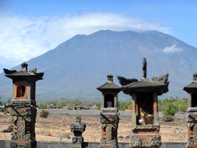 A general view shows Mount Agung behind Balinese Hindu temples seen from Karangasem on the Indonesian resort island of Bali. Picture: AFP