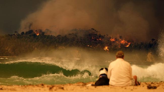 Bushfire arrives into the township of Malua Bay NSW, just south of Batemans Bay on New Year’s Eve. Picture: Alex Coppel.