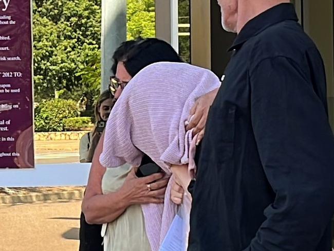 A Top End childcare centre manager Tara Eva Harding is escorted from Darwin Local Court bundled in a pink sweater by her family after facing commercial quantity drug charges.