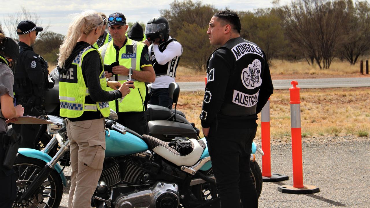 Members of the Mongols outlaw motorcycle club fuel up in Alice Springs before being stopped by police on the Stuart Hwy on a run to Darwin on October 12, 2022. Picture: Jason Walls