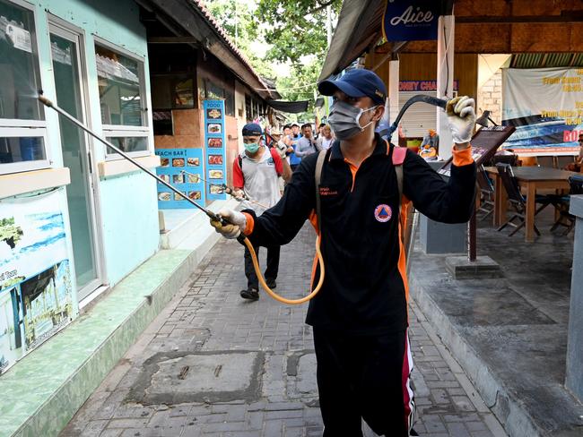 A health worker sprays disinfectant as a preventive measure against the spread of COVID-19 in Sanur, Bali. Picture: AFP