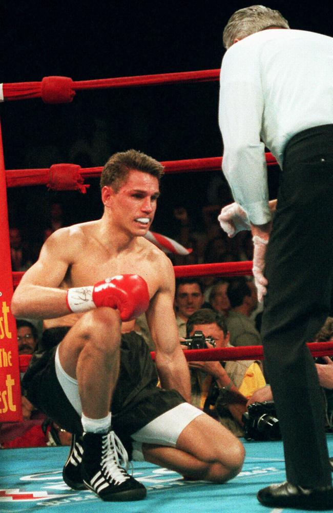 Troy Waters fights to get back up during a WBC Super Welterweight fight against Felix Trinidad.