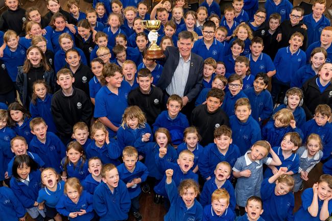 Former VRC chief steward Des Gleeson takes the trophy to a schools in Yea, Victoria. Picture: Jay Town