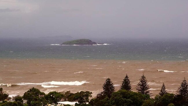 Flood waters reach the ocean off Hills Beach at Korora last month.  Photo by Evol Coutman.