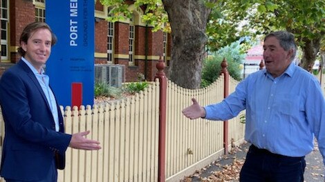 Outgoing Port Melbourne Primary principal Peter Martin (right) observes social distancing laws to welcome Rohan Cooper to the top job.