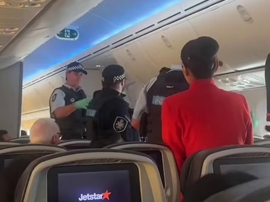 A drunken Jetstar passenger had to be forcibly removed from a flight by police after allegedly directing racist abuse at flight attendants. Source: rukaiya128