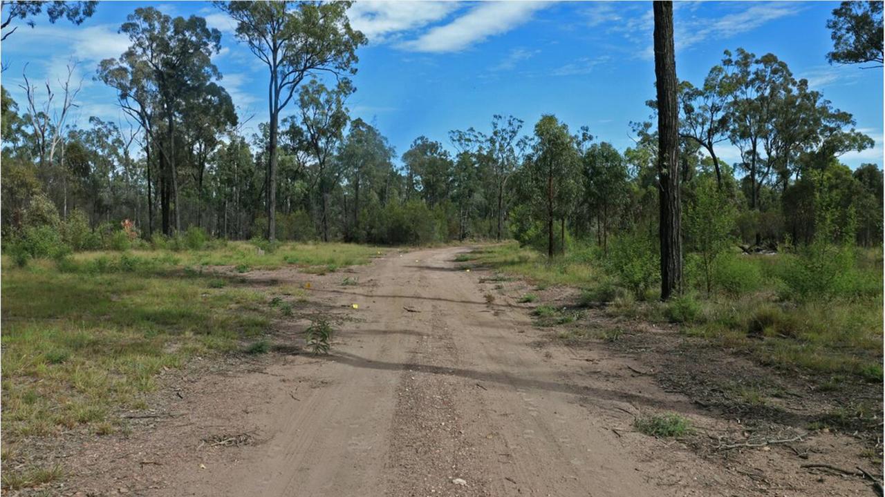 The start of the driveway into the Train property where Constable McGrow and Constable Arnold were murdered, with multiple evidence markers on the ground.