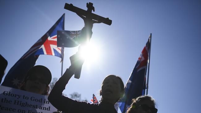 George Pell supporters sing prayers outside the High Court yesterday. Picture: AAP