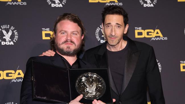 US director Brady Corbet, poses in the press room with the silver medallion for his Directors Guild of America Theatrical Feature Film nomination. Picture: AFP.