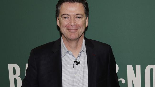 Former FBI director James Comey poses for photographs at a Barnes &amp; Noble book store. Picture: AP.