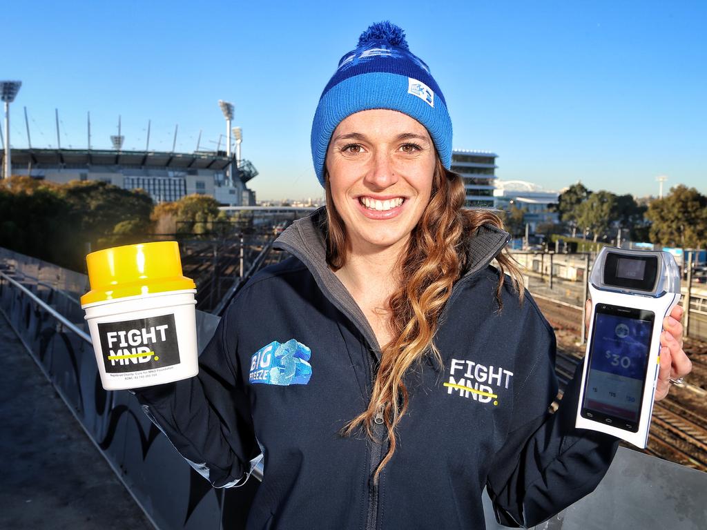 Bec Daniher with a traditional donation tin and a BladePay mobile payment device ready for Fight MND donations outside the MCG on Wednesday, June 7, 2017, in Jolimont, Victoria, Australia. Picture: Hamish Blair