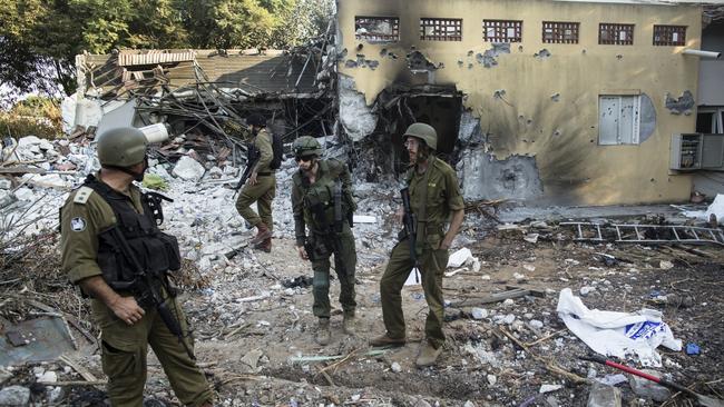 Israeli soldiers inspect houses that were destroyed in a Hamas attack on the kibbutz on October 14 in Be'eri, Israel. Picture: Getty