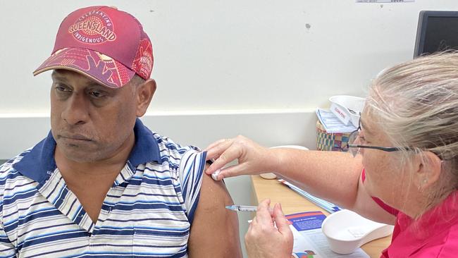 Torres and Cape Hospital and Health Service primary healthcare centre Cluster Coordinator George Morseau is vaccinated by Nurse Immuniser Alison Wolf on Saibai Island.