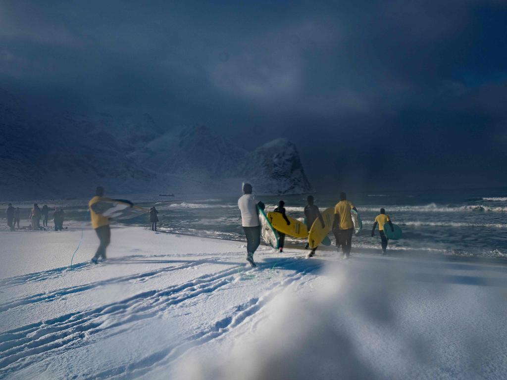 People attend a surfing lesson, on March 11, 2018, in Unstad, northern Norway, Lofoten islands, within Arctic Circle as air temperature drops minus 13°C and water temperature above 4°C. Picture: AFP