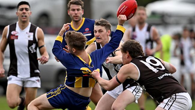 EDFL: Rupertswood’s Mitchell Johnston gets hauled down by Craigieburn’s Hayden Brown. Picture: Andy Brownbill